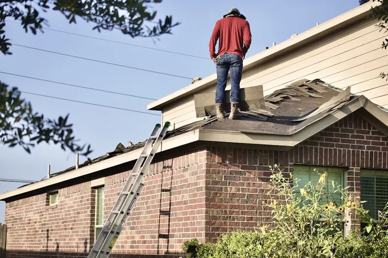 Professional roofer working on a residential roof in Irving Park